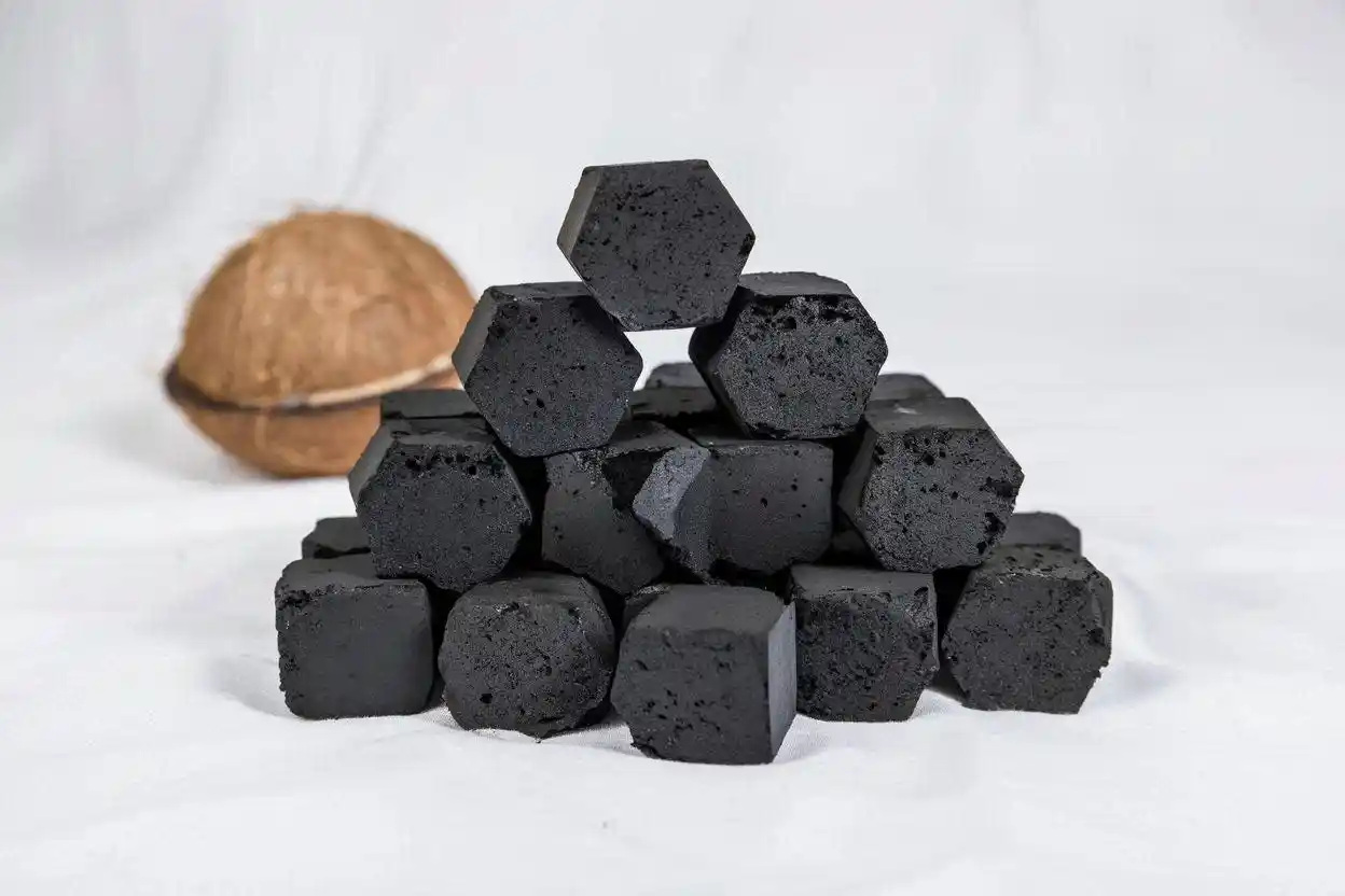 Durable coconut charcoal briquettes stacked neatly showing dense texture and quality structure for long-lasting burning